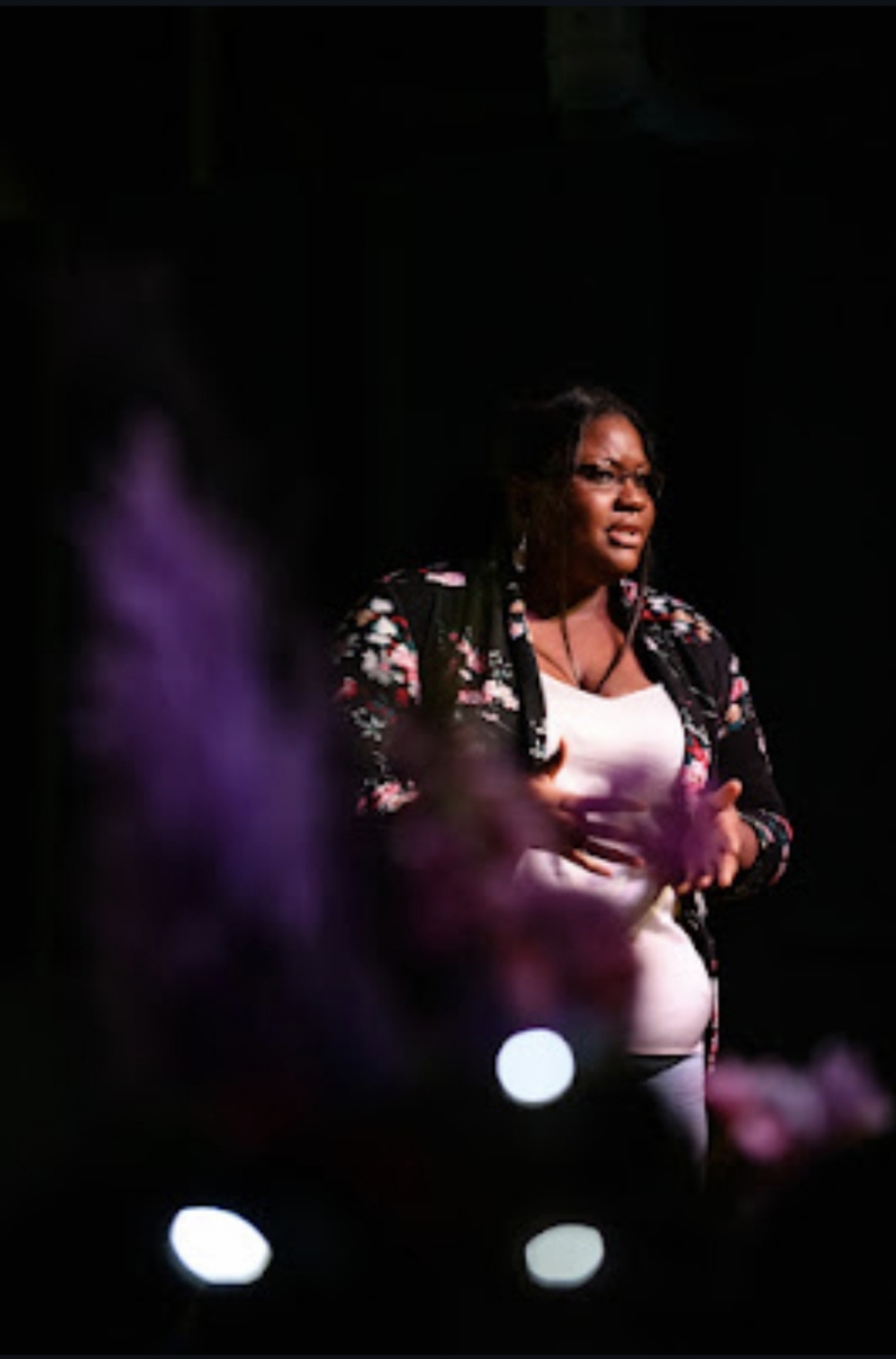 At the microphone, Erica connects with the audience during an event that brought her filmmaking into a shared community arts space.