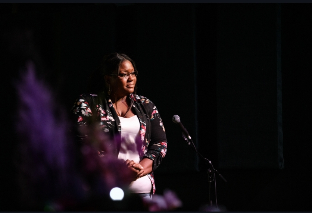 A closer look at the live event: a microphone, a listening audience, and a chance to connect through the arts.