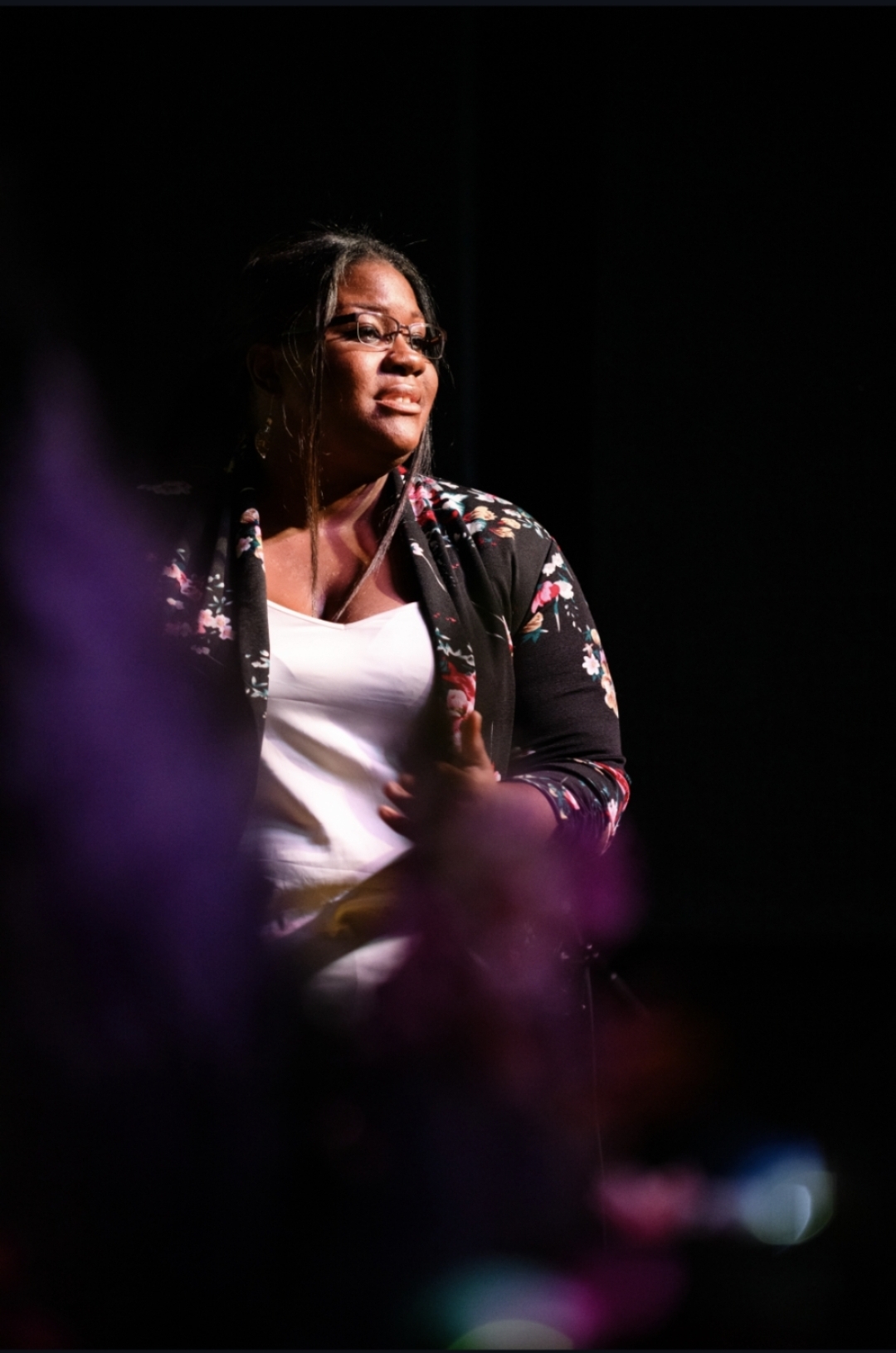 Erica pauses at the microphone during her Art Week appearance—a portrait of the filmmaker beyond the camera.