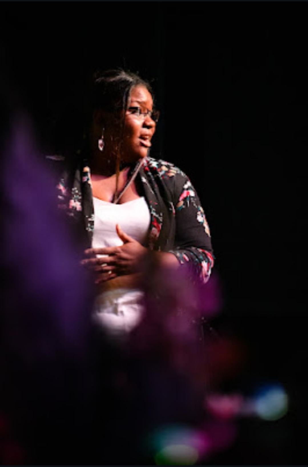 An expressive moment onstage at Des Moines Art Week, celebrating film, conversation, and creative community.