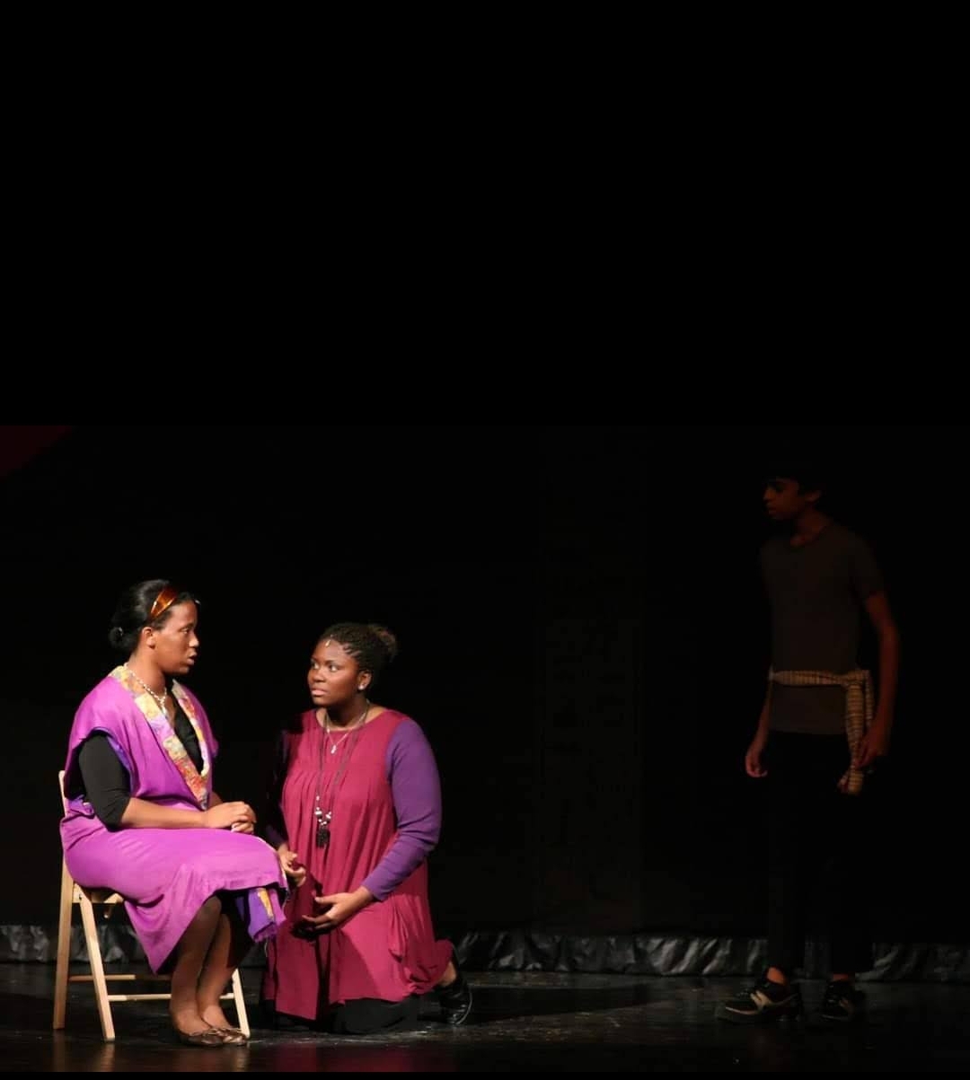 A quieter dramatic scene centers on an intimate exchange between characters. Focused listening, stillness, and emotion carry the story as powerfully as a large ensemble number.