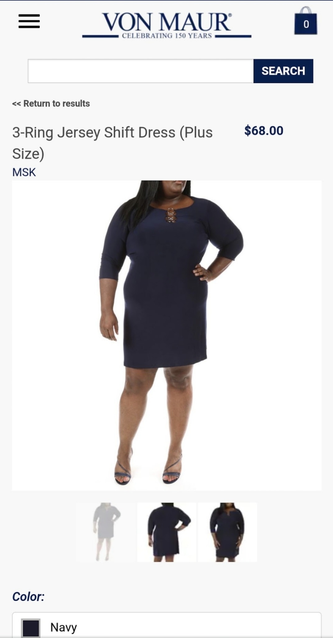A dark jersey dress is styled with a hand-on-hip pose that defines the silhouette and gives the retail image a confident presence.